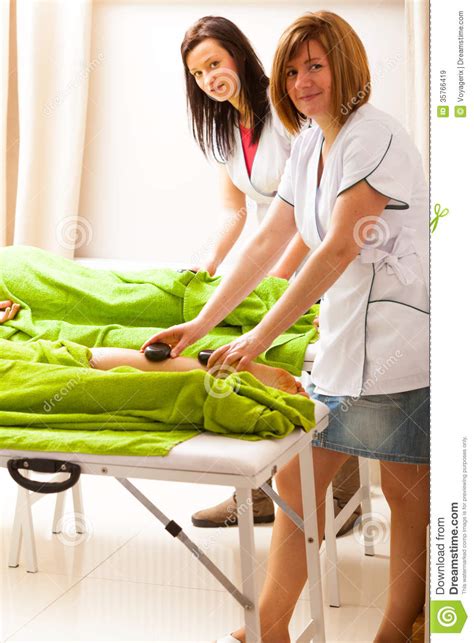 Beauty Salon Women Getting Spa Hot Stone Legs Massage Stock Image