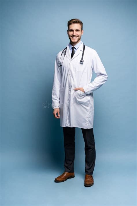 Full Length Young Medical Doctor On Blue Background Stock Photo