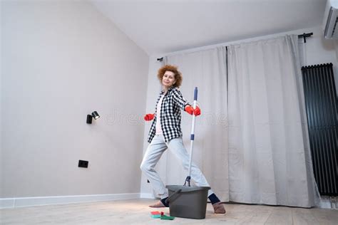 People Housework And Housekeeping Concept Happy Senior Woman In Protective Gloves Cleans Floor
