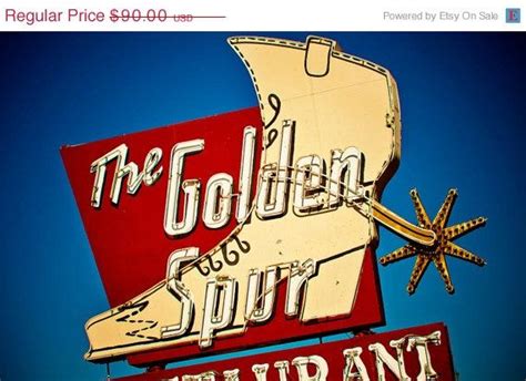 The Golden Spur Restaurant Sign Is Red And White With Gold Lettering On