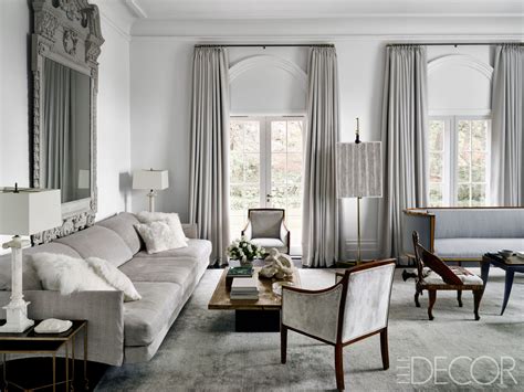 On either side of the mirror, wall sconces hold pillar candles. 10 Gray Living Room Designs to Improve your Home Decor