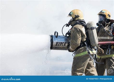 Two Firefighters Extinguish Fire From Fire Hose Using Firefighting Water Foam Barrel With Air