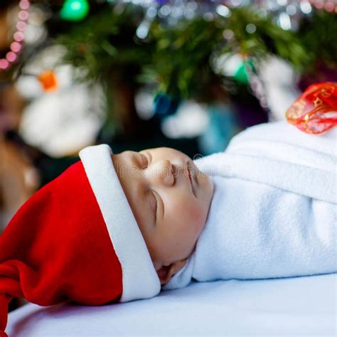 Beautiful One Week Old Newborn Baby Wrapped In Blanket Near Christmas