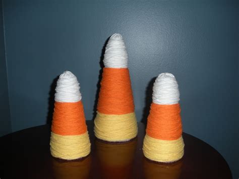 Display your wigs or masks for all to see! Halloween Decoration. Wrap yarn around styrofoam cones ...