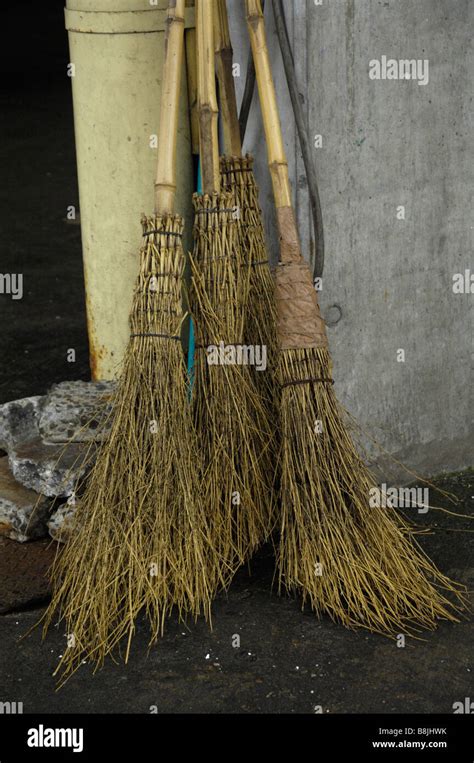 Traditional Bamboo Brooms Lean Against The Wall At Tokyos Tsukiji Fish