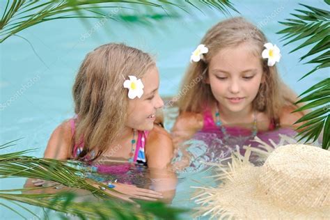 Portrait Of Two Girls In A Swimming Pool Stock Photo By ©zagorodnaya