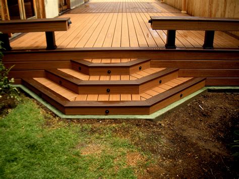 Trex Deck With Custom Steps And Green Concrete Curb To Prevent Fascia