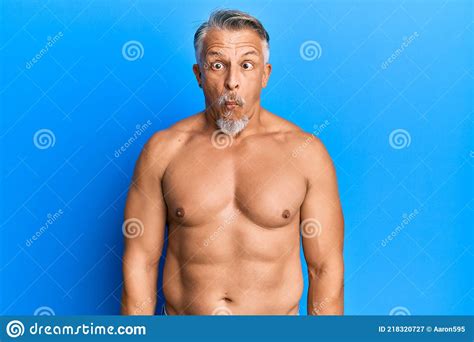 Middle Age Grey Haired Man Standing Shirtless Making Fish Face With