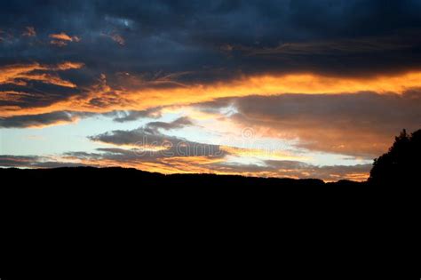 Scenic Sunset Behind Some Mountain Peaks And Hills Stock Photo Image