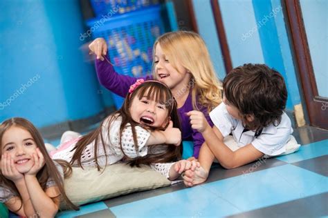 Playful Children Lying On Floor Stock Photo By ©simplefoto 33164653