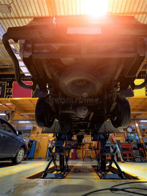 Car On Hydraulic Lift In Auto Repair Shop Stock Photo Image Of Repair