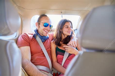 Affectionate Couple Riding In Back Seat Of Car Stock Image F022