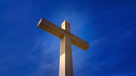 Easter Cross Against Blue Sky Background With Clouds Moving Slowly In