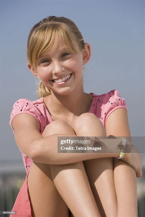Teenaged Girl Sitting With Knees Up High Res Stock Photo Getty Images