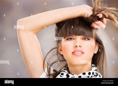 Pretty Woman Holding Her Hair With One Hand Stock Photo Alamy