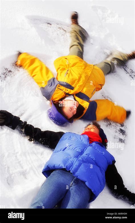 Two People Making Snow Angels Stock Photo Alamy