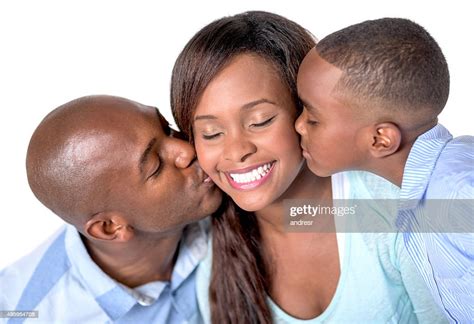 African American Husband And Son Kissing A Woman High Res Stock Photo