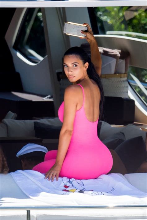 Kim Kardashian Reveals Tiny Waist In Skintight Neon Pink Catsuit In
