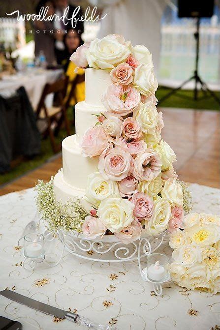smooth buttercream wedding cake with fresh garden floral cascade i like the cascading flowers