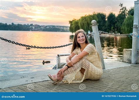 Woman Sitting On Pier Against Water And Sunset Stock Photo Image Of Dock Female