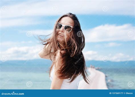 Young Beautiful Stylish Woman Brunette Girl With Flowing Hair In Sunglasses Is Not The Shore Of