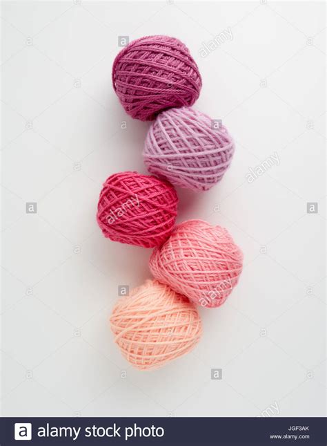 Knitting Yarn Balls In Pink Tone Colored Yarn On A White Background