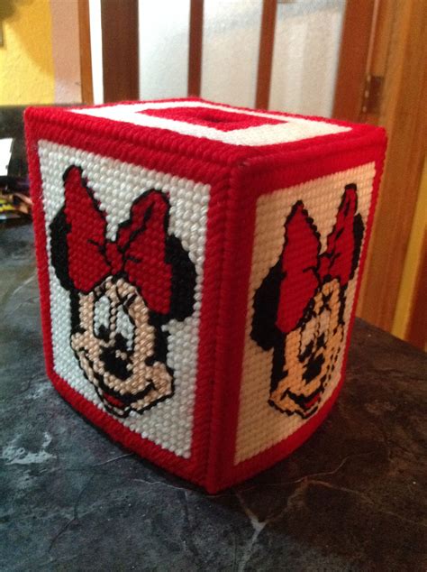 A Red And White Beaded Box With Mickey Mouse On Its Face Is Sitting On