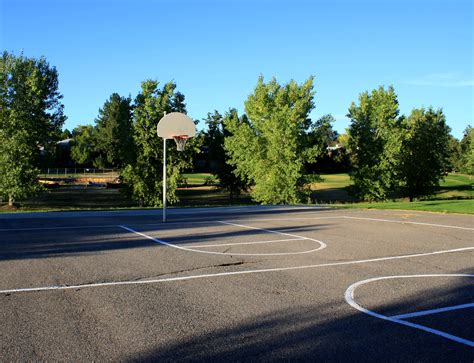 Free Photo Of An Outdoor Basketball Court With Blacktop Pavement