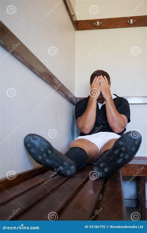 tired rugby player covering face while sitting on bench stock image image of people rugby