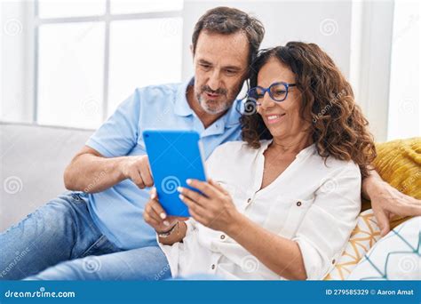 Man And Woman Couple Using Touchpad Sitting On Sofa At Home Stock Image Image Of Relaxing