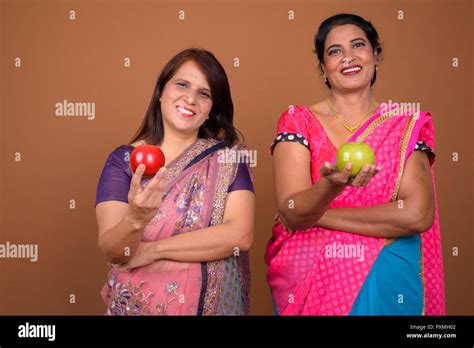 Two Happy Indian Woman Holding Healthy Apple Fruit Stock Photo Alamy