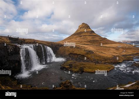 Kirkjufellsfoss Waterfalls With The Kirkjufell Mountain At