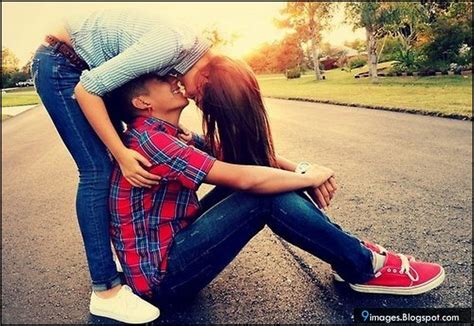 Teenage couple lying down and laughing. Cute, couple, kiss, sunset, road, outdoor