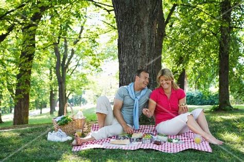 A Couple Having A Picnic Under A Tree Buy Images Stockfood