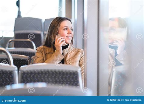 Woman Talking On The Phone While Riding The Bus Train Or Metro Stock