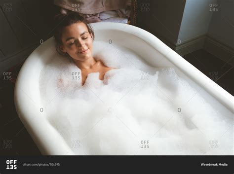 Woman Taking A Bubble Bath In Bathroom At Home Stock Photo OFFSET