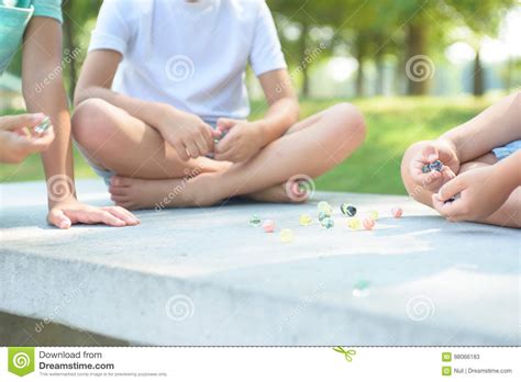 Kids Playing Marbles Game Outside Stock Image Image Of Legs Quick