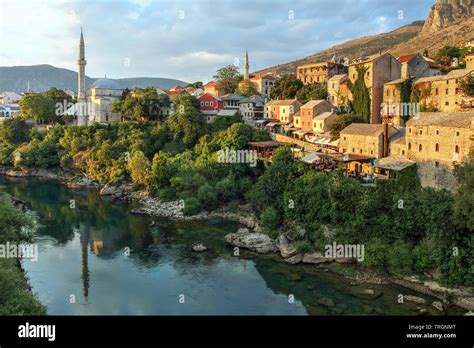 Golden Hour Over The Neretva River Banks Of The City Of Mostar In
