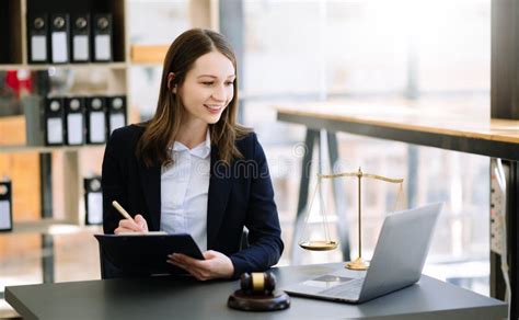 Beautiful Woman Lawyer Working And Gavel Tablet And Laptop In Front