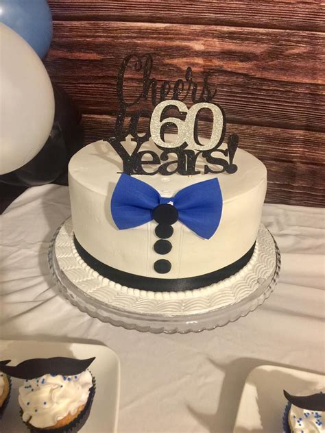 A Birthday Cake With A Blue Bow Tie On It