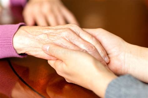 Helping Hands Hands Of Young Adult And Senior Women Care And Elderly