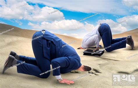 Businessman Hiding His Head In Sand Escaping From Problems Stock Photo