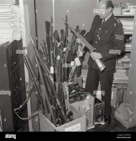 1960s Historical Male British Police Sergeant Holding A Rifle