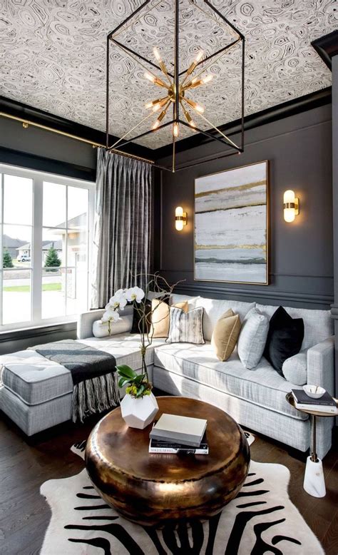 In this living room, black provides elegance while soft gold fulfills ambiance for a restful living space for whole family members. black and gold decor | Transitional decor living room