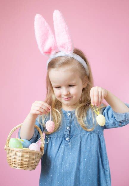 Premium Photo Little Girl With Bunny Ears Standing With Wooden Basket