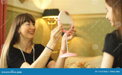 mom is showing her daughter a mirror stock footage video of home beauty 113157836