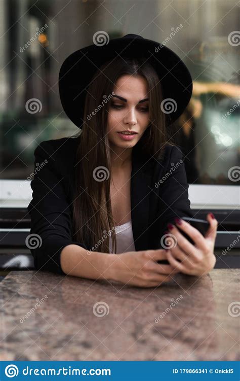 A Woman Sitting Down Talking On A Cell Phone Stock Image Image Of
