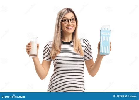Young Woman Holding A Glass Of Milk And A Milk Carton Stock Image