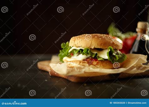 Hamburger On A Black Background With Ingredients Delicious And Fast