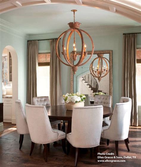 Diy multi light bulb dining room chandelier. Orb chandelier lighting over a round table creates an ...